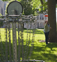 Junior MEredith Tubbs plays disc golf on the college's nine-hole course. (Photo by Jamie Kelly)