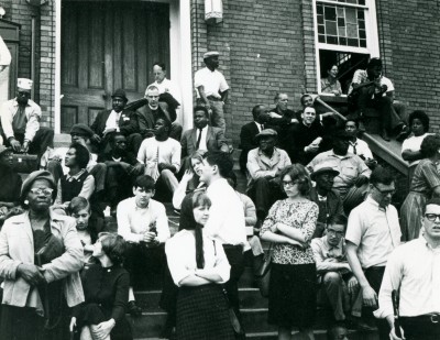 Civil rights activists assemble on the stairs of the Dexter Avenue King Memorial Baptist Church, Montgomery, Ala., where the Montgomery Bus Boycott was organized in 1955-1956. John Watson ’68 is at center. Roger Davis ’65