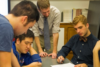 Professor Hans Hassell works with students during Campaigns & Elections