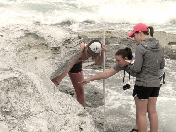  India Pearce ’15, Nicole Werling ’15, and Hannah Garvey ’15 measure a vertical section of rock while studying Pleistocene (fossil) sand dunes in the Bahamas. Photo by Ben Greenstein