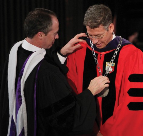 John McGrane '73, chair of the Board of Trustees, places the presidential medallion on President Jonathan Brand. McGrane and his wife, Martha Benson McGrane '73, offered to update the medallion, originaly designed for President Stumpf in the 1960s