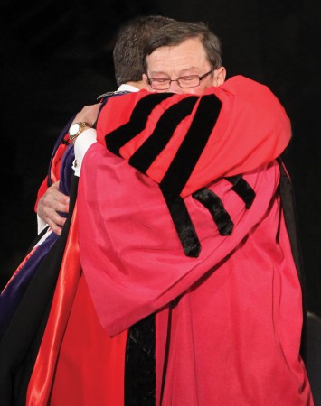 President Brand hugs President Garner after being presented with the keys to College Hall as a symbol of office.