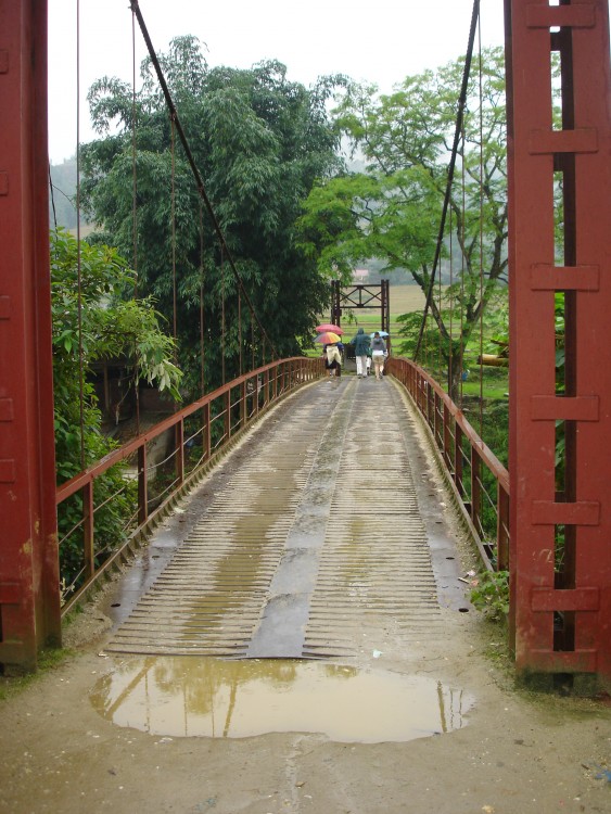 Locals walk through the rain to a temple in Hanoi, Vietnam, near where Allie Jagielo '11 served a Dimensions-sponsored internship working with disabled children.