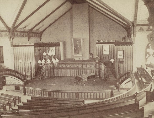 The original chapel auditorium featured a portrait of Cornell founder George Bowman and extensive stenciling, seen in detail in Chapman’s building instructions (below).