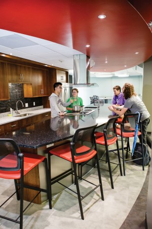 Students engage in conversation in Dows Hall’s industrial-grade kitchen. Photo by Robyn Schwab Aaron ’07