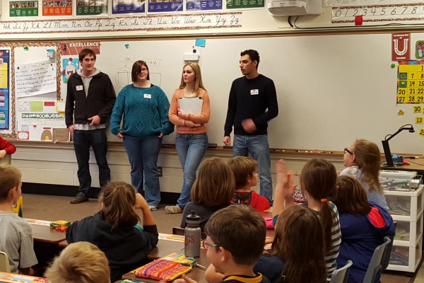 Joe Keller ’19, Cody-Lee Bankson ’18, Sami Vetter ’19, and Chris Baluja ’19 speaking to a third-grade class at Mount Vernon Elementary.