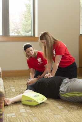 Sydney Cooper ’18 and Morgan Champagne ’17 demonstrate their skills on patient models in the Thomas Commons. (Photo by Envisage Studios) 