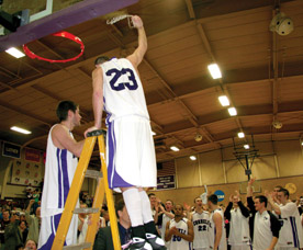 Seniors Griffin LaDew and Michael Tierney cut down the nets after defeating Wartburg 58-56 in the HAC Championship game. (Photo by Blake Rasmussen '05)