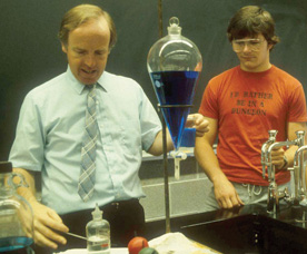 Truman Jordan, professor emeritus of chemistry, taught both before and after the block plan. His early work helped create the modern template for how laboratory experiments are done on the block pna. Here he's shown demonstrating a lab to his students. 