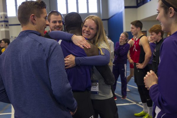 coach Karly Cochrane hugs sprinter Husani Newbold ’18 after a record-breaking run