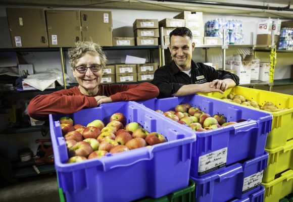 Mary Zahradnik of Buffalo Ridge Orchard delivers apples to Bon Appétit General Manager James Richards