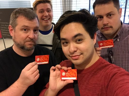 Students and Professor Olinger hold their NYC Public Library cards