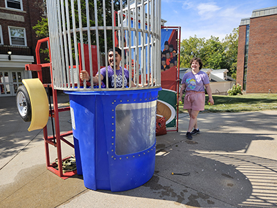 Studenet standing up in a dunk tank after being in the water.