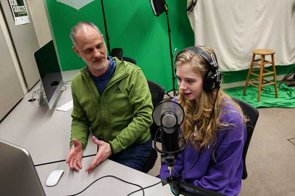 Sidney Brown works with staff in the Academic Technology Studio.