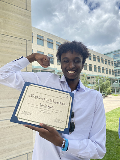 Yonis Said holds a certificate of completion for the summer health program he was involved in.
