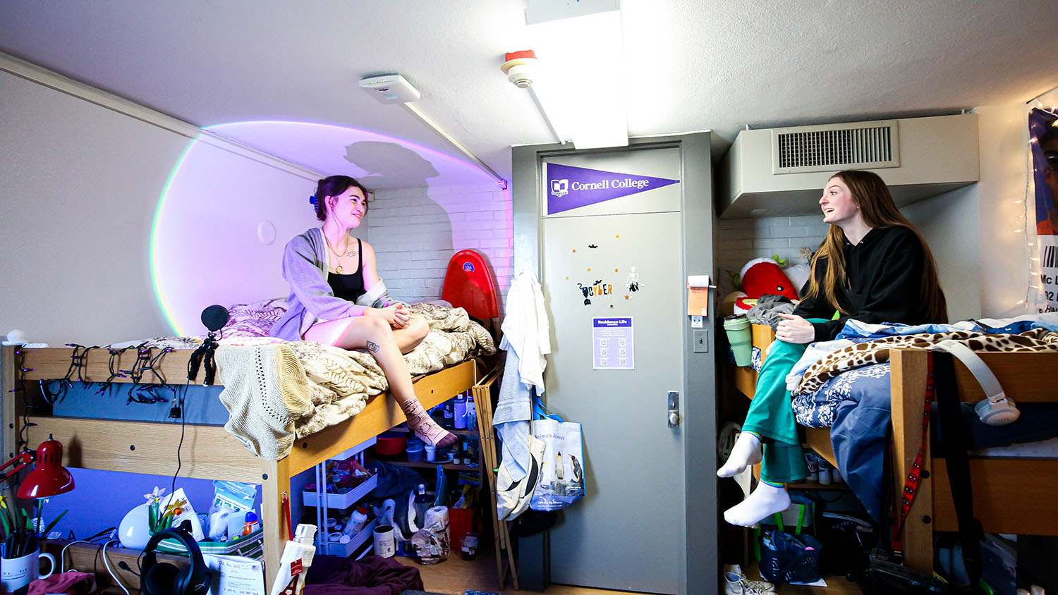 Two students on the lofts in their residence hall room.