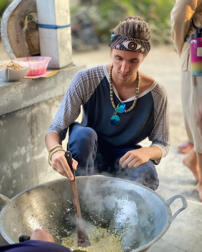 Beckett cooks food in a large bowl.