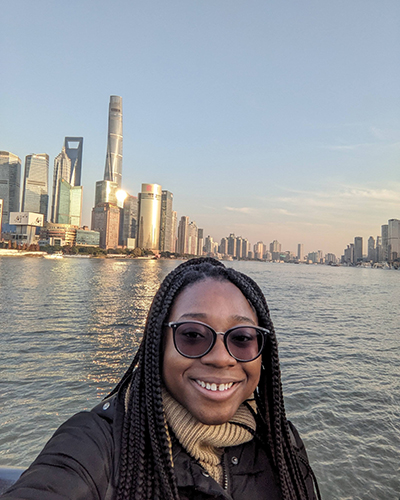 Kimberly Maitland ’24 with the Shanghai skyline behind her.
