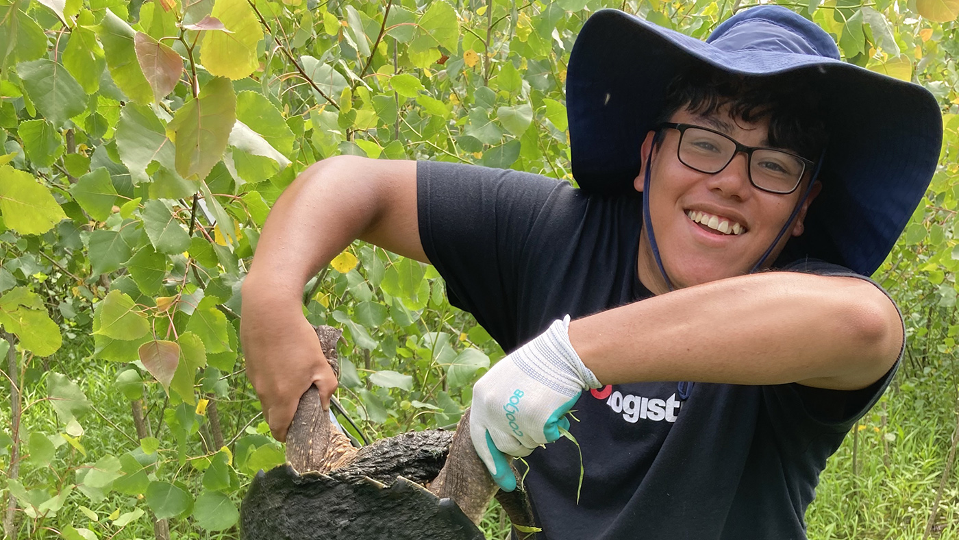 Jason Ramos holds up a large snapping turtle