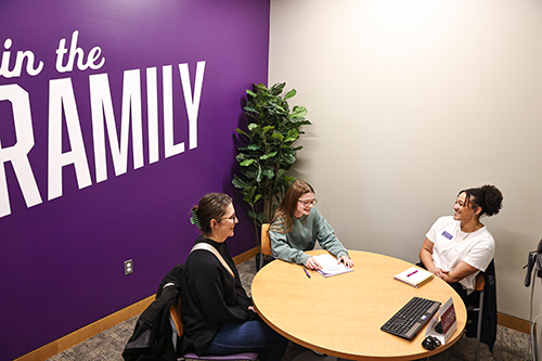 Washington in a room with a student and their parent.