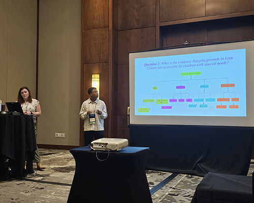 Two students presenting at a conference