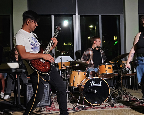 A studend playing a guitar 