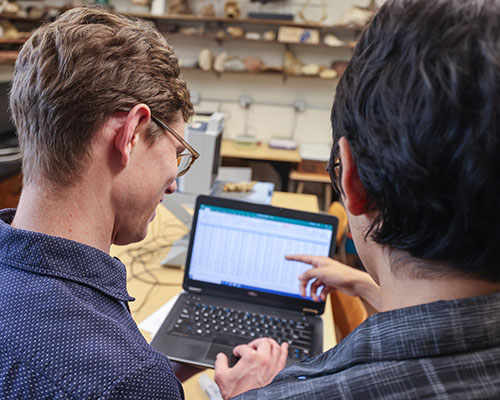 Kevin Zazueta '27 and Assistant Professor of Geology Andrew Walters discuss data gathered during their research.