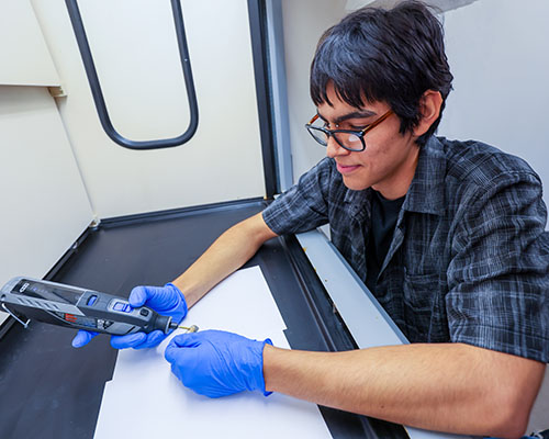 Kevin Zazueta '27 prepares one of the samples for analysis.