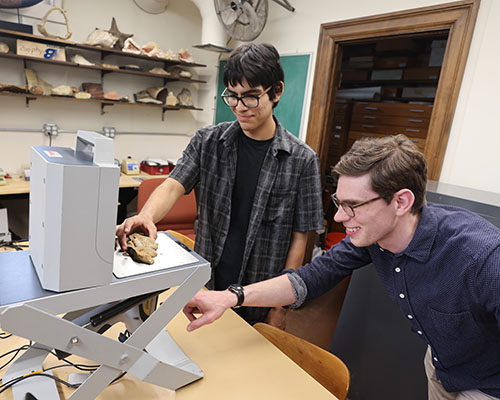 Kevin Zazueta '27 and Assistant Professor of Geology Andrew Walters use the XRF scanner to analyze samples from the mass mortality bed.