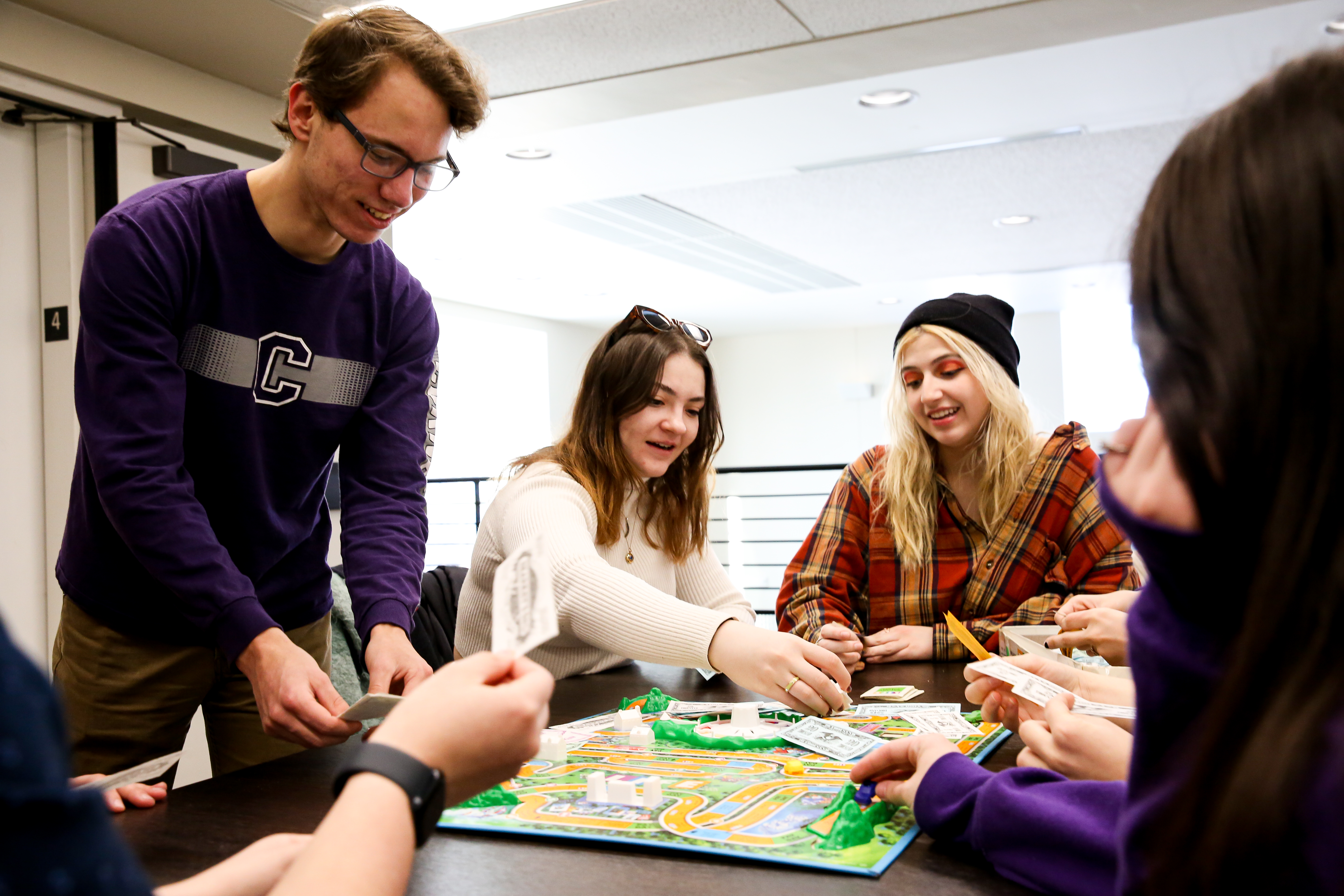 A group of Cornell students plays a board game