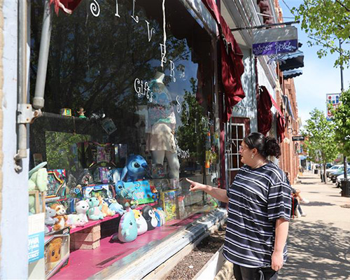 A Cornell student walking along Main Street in Uptown Mount Vernon.