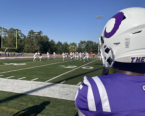 Football player looks on to see the field during the Homecoming football game 2024.