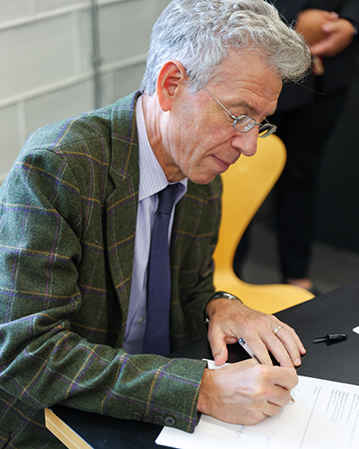 President Brand signing documentation