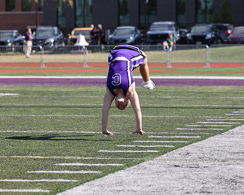 A cheerleader performs a flip at the Homecoming 2025 game.
