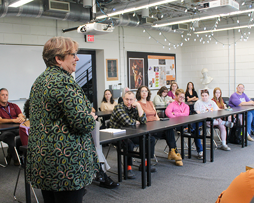 Professor Chris Penn-Goetsch shares history with the faculty, staff, and students at the Sept. 30 gathering.