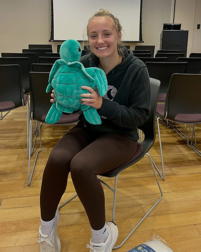 A student shows off their finished critter.