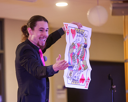 Magic John performs a card trick.