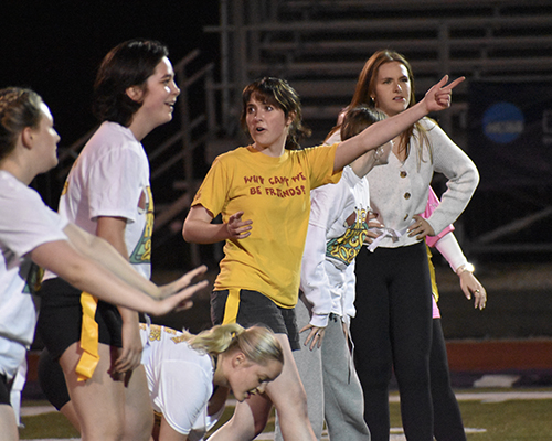 The Theta's line up for a play during the Homecoming 2025 powderpuff football game.