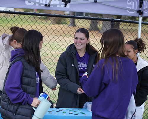 Brianna Risley '27 talks to other students at the soccer dedication game. 