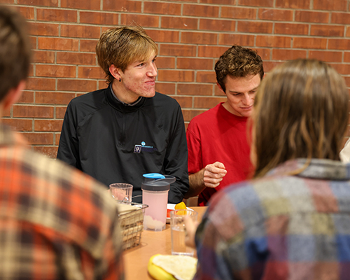 Issac eats with teammates.