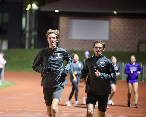 vanWestrienen running with teammate Jake Bach during an early morning practice.