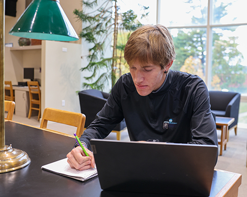 Isaac working on homework in the library