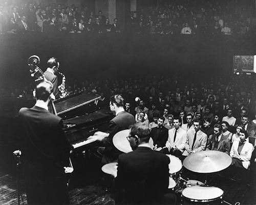 Dave Brubeck plays before a packed crowd in King Chapel on April 12, 1957, with alto saxophonist Paul Desmond, bassist Bob Bates, Brubeck, and drummer Joe Dodge.