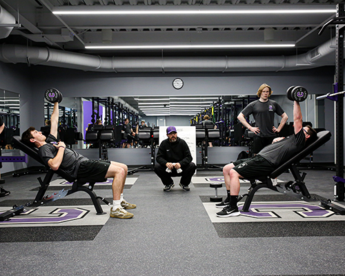 Coach Lamb supervises lifts in the weight room.