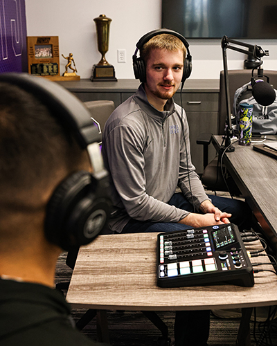 Carlson interviews Tony Gomez ’25, running back for the Rams football team, during one of his podcasts.