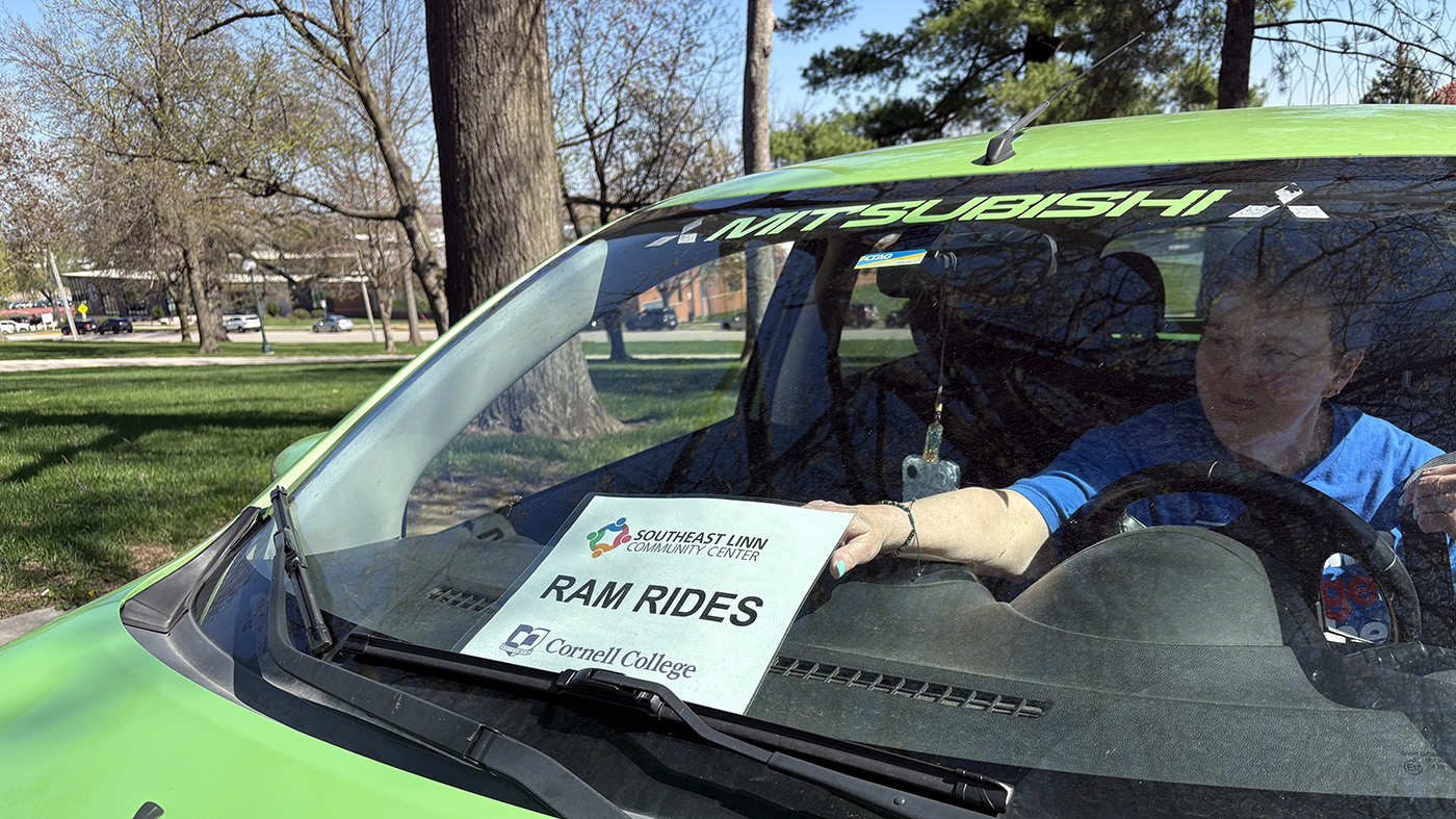 Woman puts sign in her window for Ram Rides