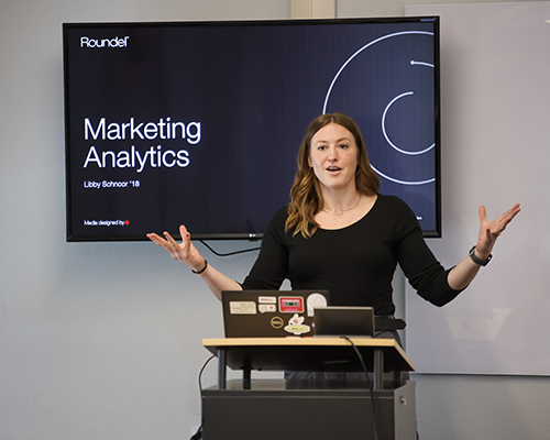 Libby Schnoor '18 presents to a class during her visit to campus.