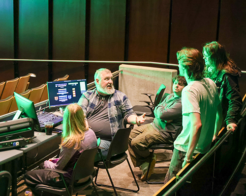 Scott Olinger works with students to design stage lighting.