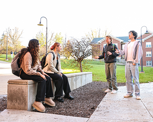 Cornell students stop and chat on the way to or from class.