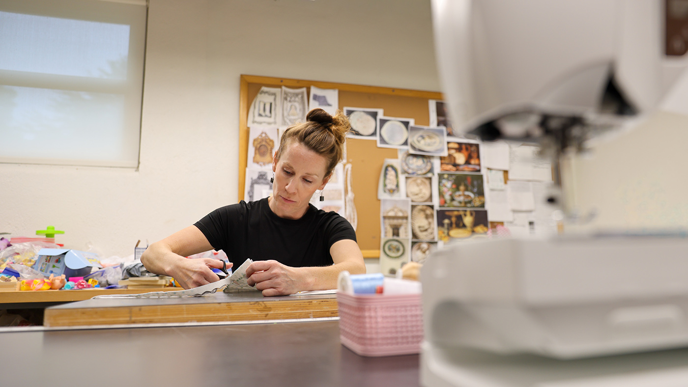 Professor looking at the camera in her art studio.